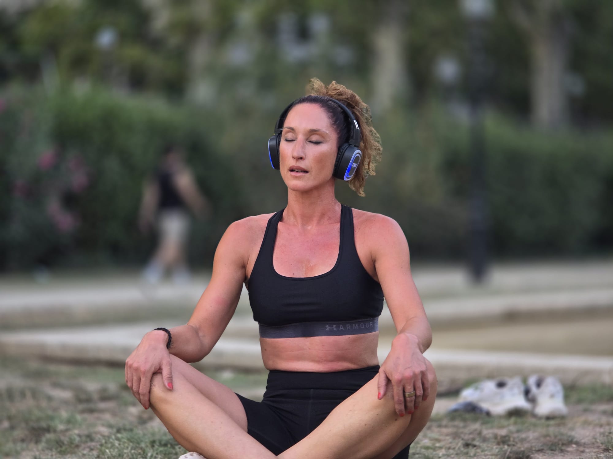 Melissa Sapmaz en meditación activa con auriculares al aire libre
